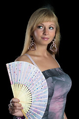 Image showing Beautiful young smiling woman with fan