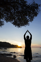 Image showing Man on coast saluting sun 