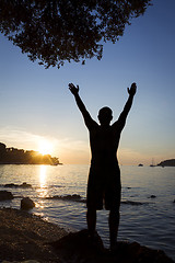 Image showing Man saluting sun on shore