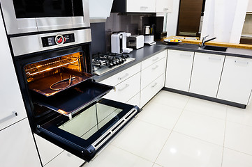 Image showing Modern hi-tek kitchen, oven with open door