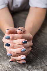 Image showing Beautiful hands with the miniature painted in a gray-colored 