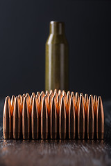 Image showing Macro shot of copper bullets that are in many rows to form a tri