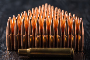 Image showing Macro shot of copper bullets that are in many rows to form a tri