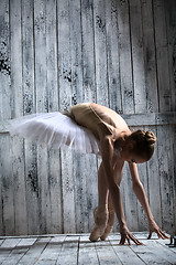 Image showing Ballerina dressed in white tutu makes lean forward