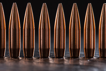 Image showing Macro shot of copper bullets that are in one row