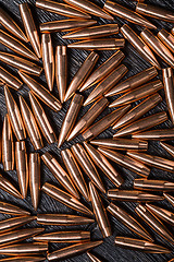 Image showing Placer copper bullets on a dark wooden background