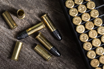 Image showing Scattering of small caliber cartridges on a wooden background
