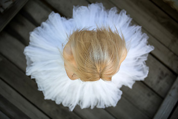 Image showing Close portrait of a cute ballerina in white tutu and blue bathin