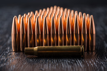 Image showing Macro shot of copper bullets that are in many rows to form a tri