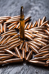 Image showing Placer copper bullets on a dark wooden background