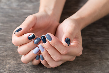 Image showing Beautiful hands with the miniature painted in a gray-colored 