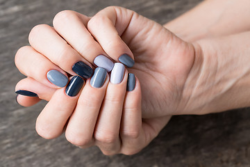 Image showing Beautiful hands with the miniature painted in a gray-colored 