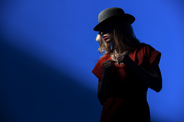 Image showing Contrast portrait of sexy blonde in a red hat