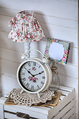 Image showing Bedside table with lamp and alarm clock