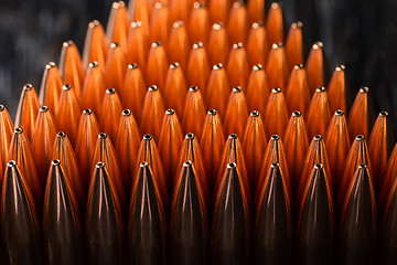 Image showing Macro shot of copper bullets that are in many rows to form a tri