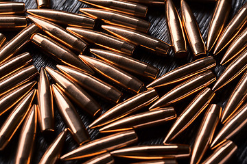 Image showing Placer copper bullets on a dark wooden background