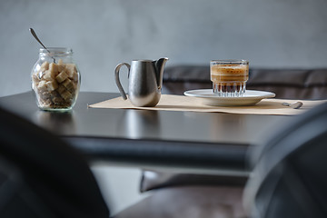 Image showing Coffee espresso on black glossy table.