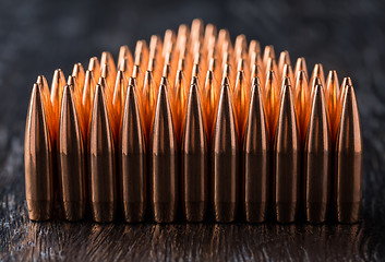 Image showing Macro shot of copper bullets that are in many rows to form a tri