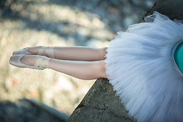 Image showing Ballerina sitting on the edge of bridge