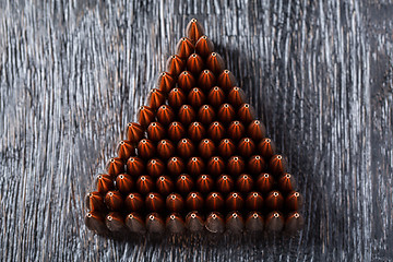 Image showing Macro shot of copper bullets that are in many rows to form a tri