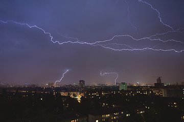 Image showing lightning strikes over night town during a thunderstorm. Kiev, U