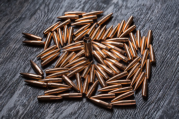 Image showing Placer copper bullets on a dark wooden background