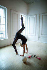 Image showing Flexible gymnast doing exercise