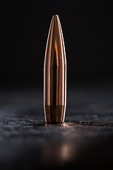 Image showing One copper bullet with bright reflections