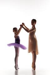 Image showing The little ballerina dancing with personal ballet teacher in dance studio