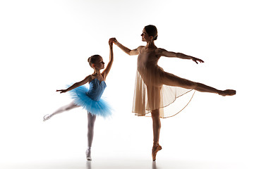 Image showing The little ballerina dancing with personal ballet teacher in dance studio