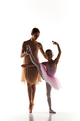 Image showing The little ballerina dancing with personal ballet teacher in dance studio