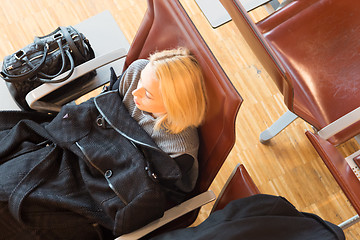 Image showing Tired female traveler waiting for departure.