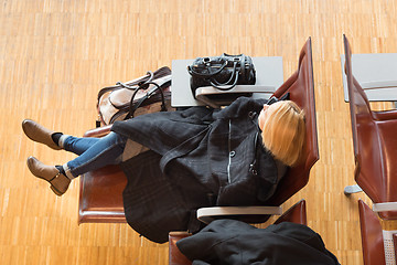 Image showing Tired female traveler waiting for departure.