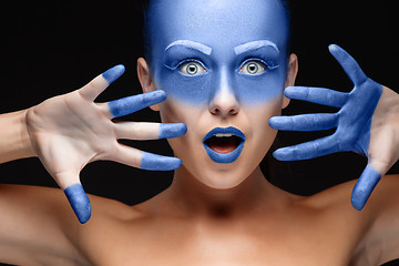 Image showing Portrait of a woman who is posing covered with blue paint