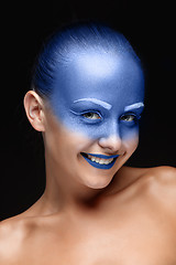 Image showing Portrait of a woman who is posing covered with blue paint