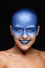 Image showing Portrait of a woman who is posing covered with blue paint