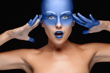 Image showing Portrait of a woman who is posing covered with blue paint