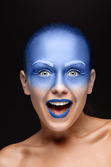 Image showing Portrait of a woman who is posing covered with blue paint