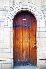 Image showing wooden parliament in london old church door and marble antique  