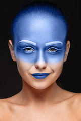 Image showing Portrait of a woman who is posing covered with blue paint