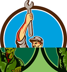 Image showing Mechanic Raising Up Spanner Circle Retro