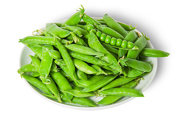 Image showing Big pile opening and closing pea pods on white plate