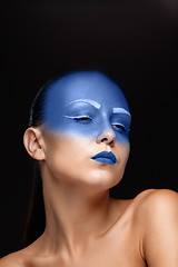 Image showing Portrait of a woman who is posing covered with blue paint