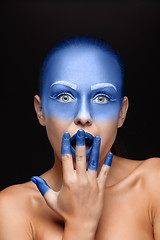 Image showing Portrait of a woman who is posing covered with blue paint