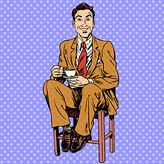 Image showing Man drinking tea sitting on the stool