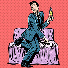 Image showing Playful man with a glass of champagne on the couch