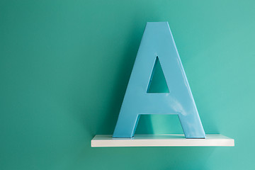 Image showing Letter A turquoise color on a white shelf.