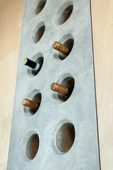 Image showing Several bottles of wine in a special concrete hole