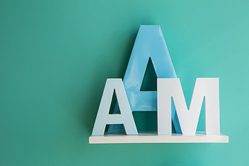 Image showing Letters A and M on a white shelf.