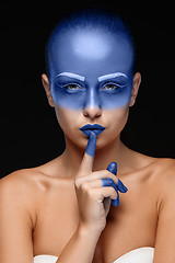 Image showing Portrait of a woman who is posing covered with blue paint